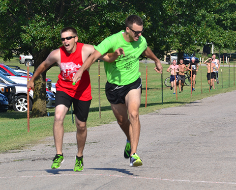 You make the call. Sam McDaniel, left, of the Spinalators crosses the finish line with Vince DeGrado of The Dore Enchies