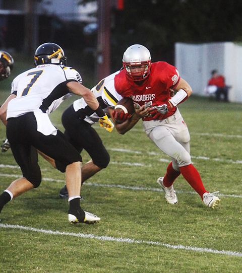 Colten Glover attempts to turn the corner against stout Andale defense.